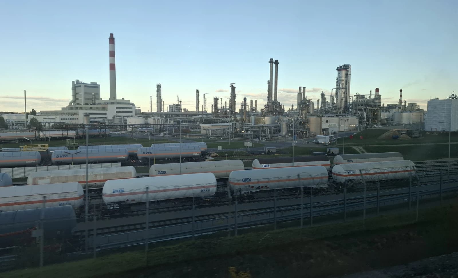 Aerial view of Schwechat oil refinery in Austria with industrial infrastructure and rail cars.