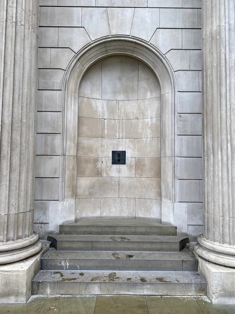 Speaking tube niche on the stone exterior of the Bank of England building.