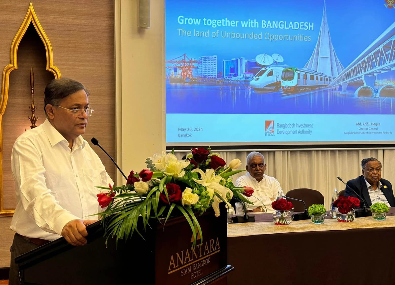 Hasan Mahmud speaking at a podium during the Bangkok Business Meeting 2024.