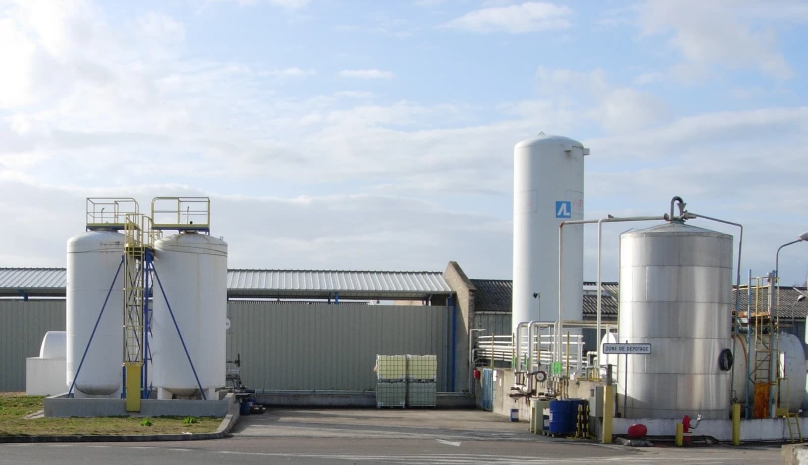 Industrial storage tanks and a large silo at a chemical facility.