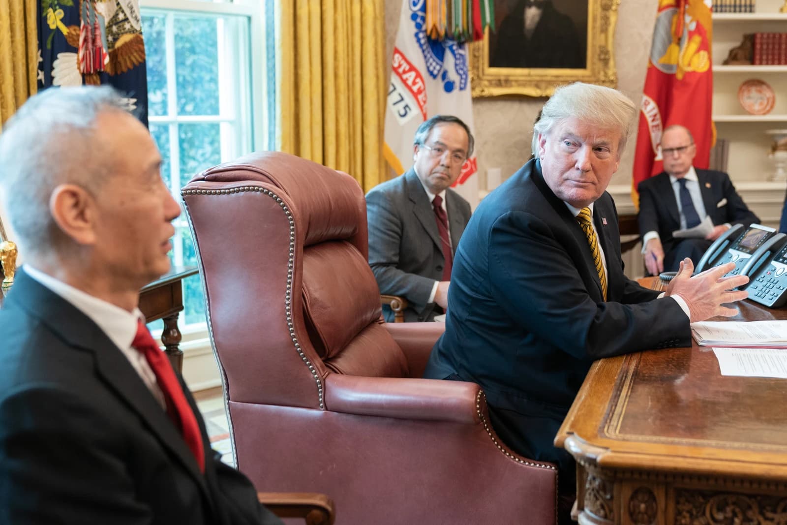 Donald Trump, US President, meets with Liu He, Vice Premier of China, at a desk.