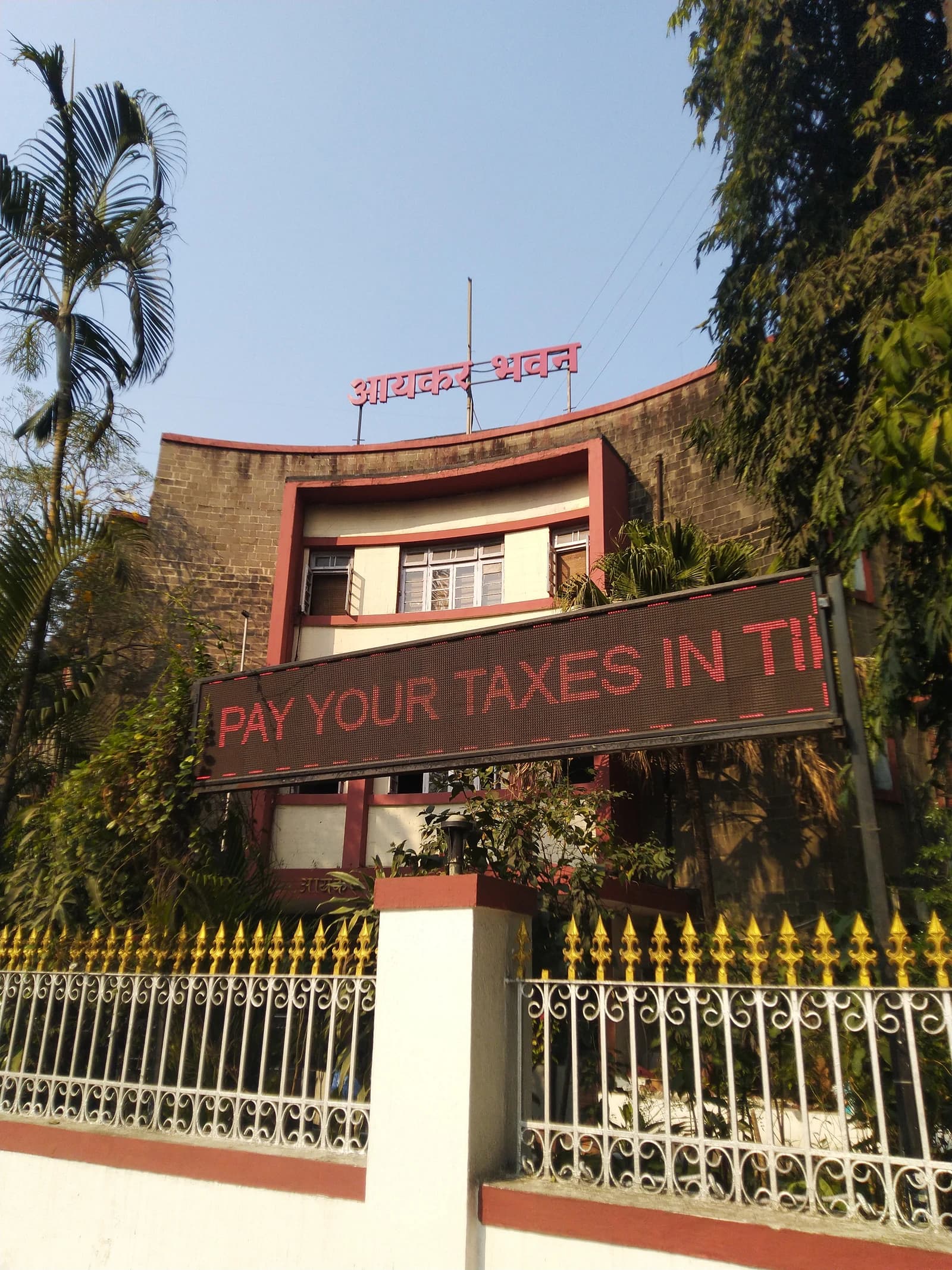Aaykar Bhavan building, Income Tax Department, with 'Pay Your Taxes in Time' message.