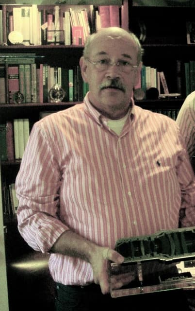 Ton Willekens, identified with ASML, holding a lens component.