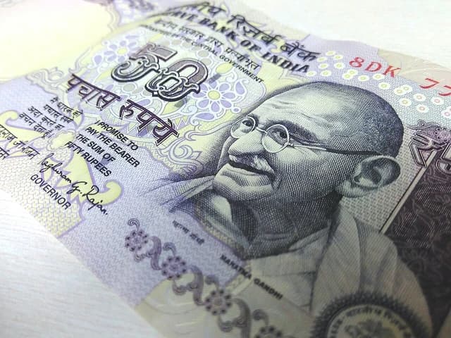 Indian 50-rupees banknote close-up featuring Mahatma Gandhi's portrait.