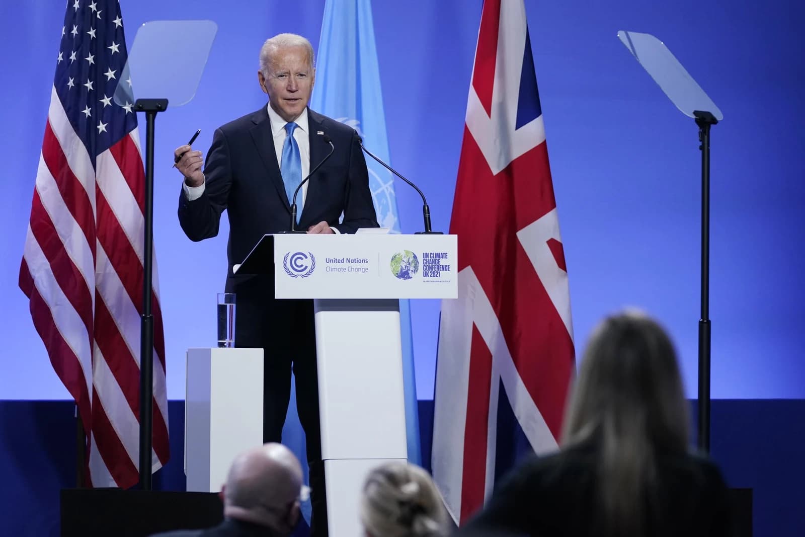 Joe Biden, President of the United States, speaks at a podium during COP26.