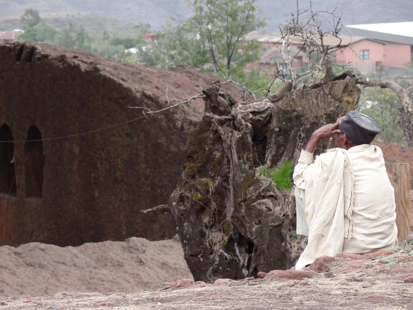 Priest sits outside the Northwestern Cluster of Rock-Hewn Churches in Lalibela, Ethiopia.