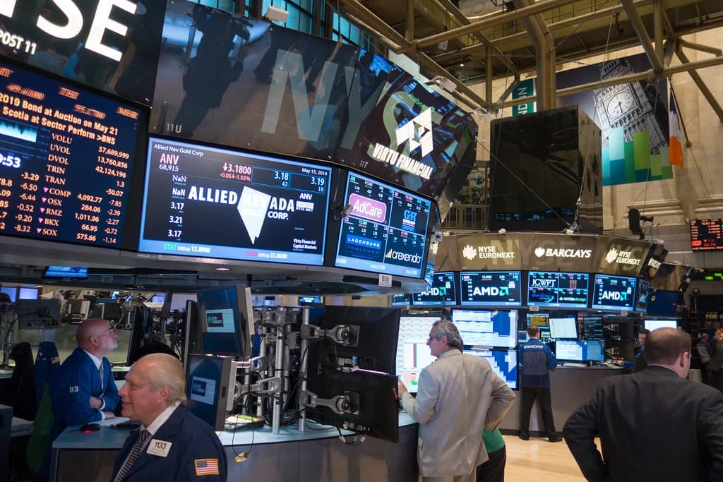 Traders work at desks on the New York Stock Exchange trading floor.