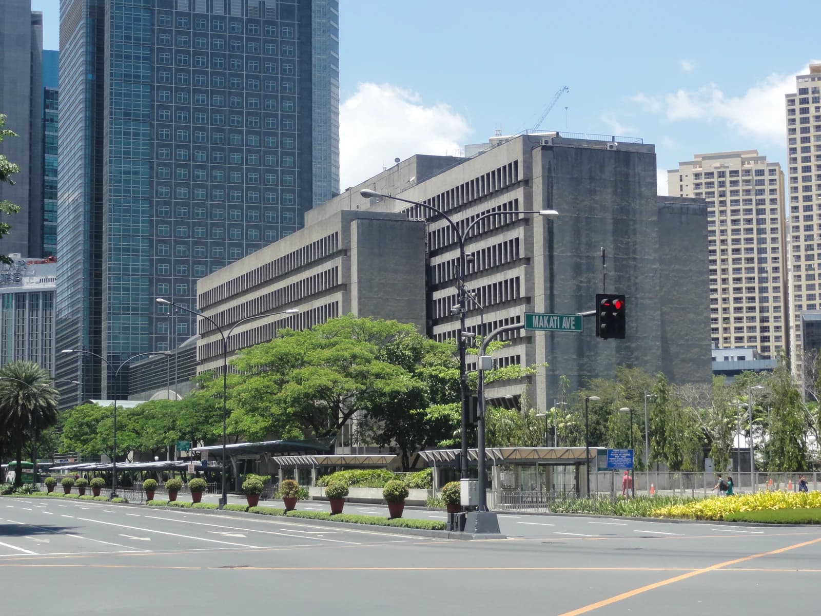Street view of Ayala Avenue with buildings and trees under a blue sky.