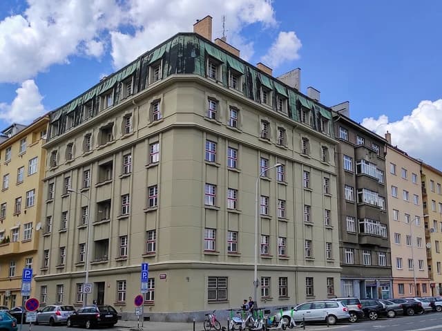 Apartment building with a green mansard roof in Holešovice, Prague, Czech Republic.