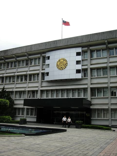 Building of MJIB headquarters in Taiwan with a flag on the roof.