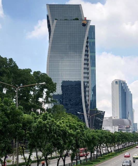 The Stock Exchange of Thailand Building in Bangkok from across a busy street.