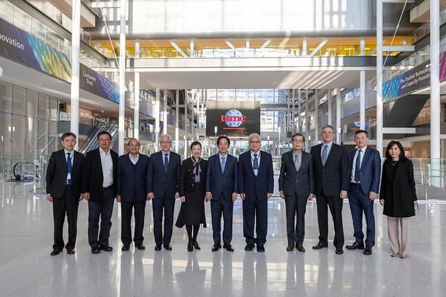 Group of executives, including Taiwan's Vice President, standing inside TSMC Global R&D Center.