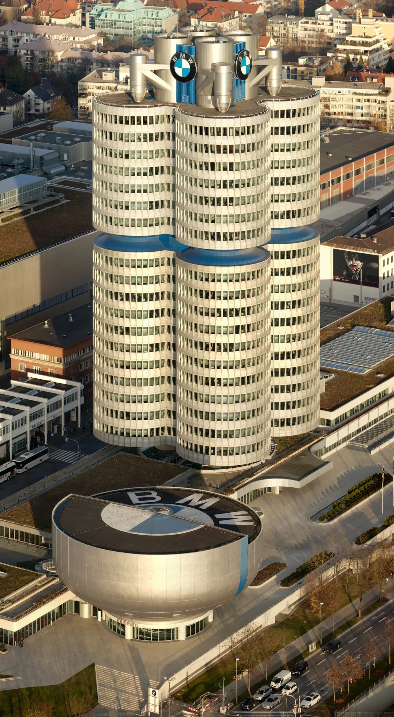 Aerial view of the BMW Headquarters, a four-cylinder tower, and the adjacent BMW Museum.