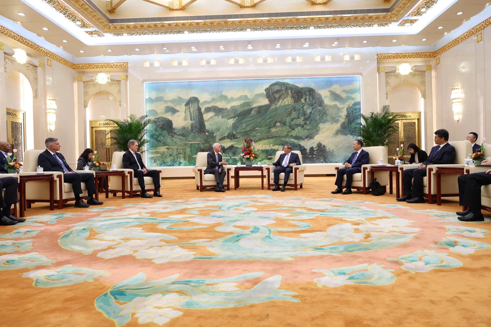 Rep. Adam Smith meets with Premier of China Li Qiang in a formal meeting room.