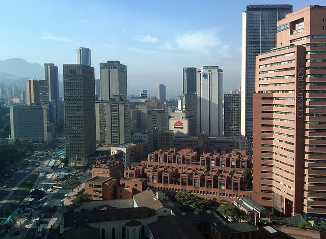 An aerial view of the Centro Internacional de Bogotá, featuring multiple tall buildings and urban streets.