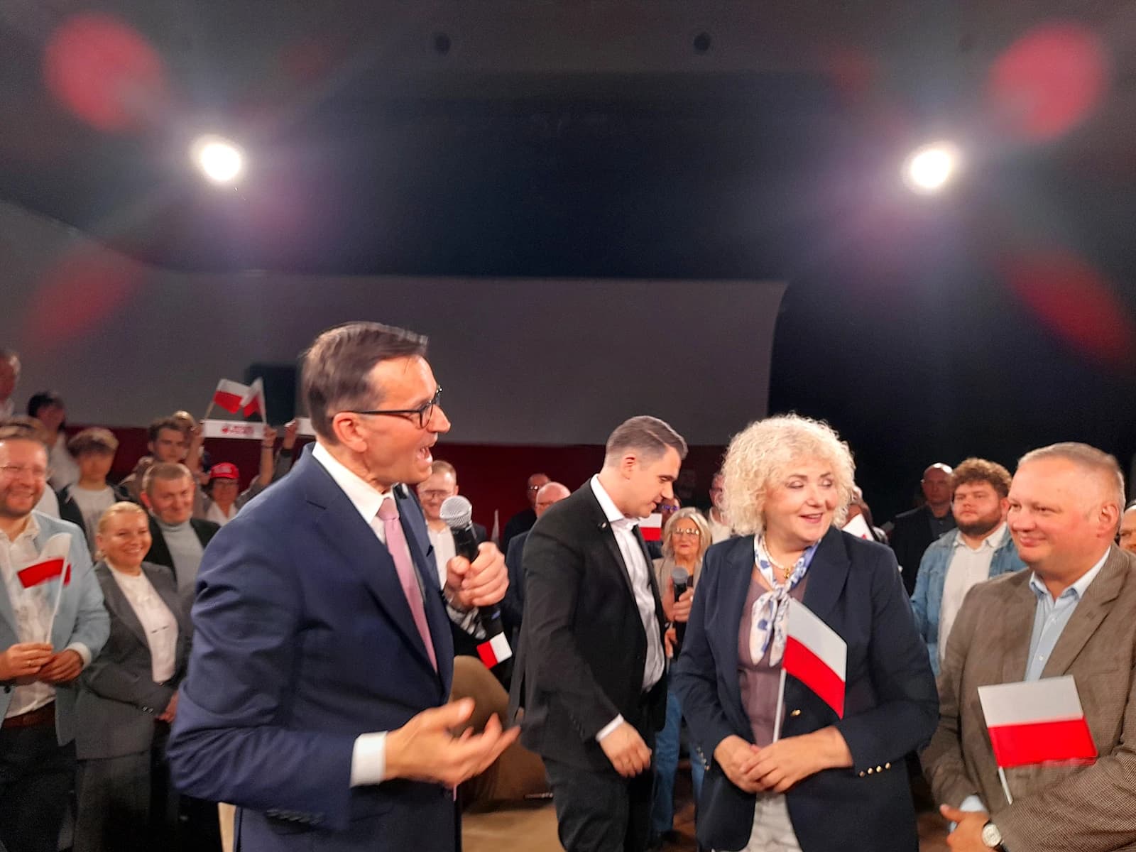 Mateusz Morawiecki, Prime Minister of Poland, speaking into a microphone at a meeting.