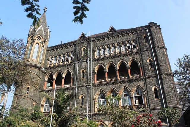 Exterior view of the Mumbai High Court building with a prominent tower.