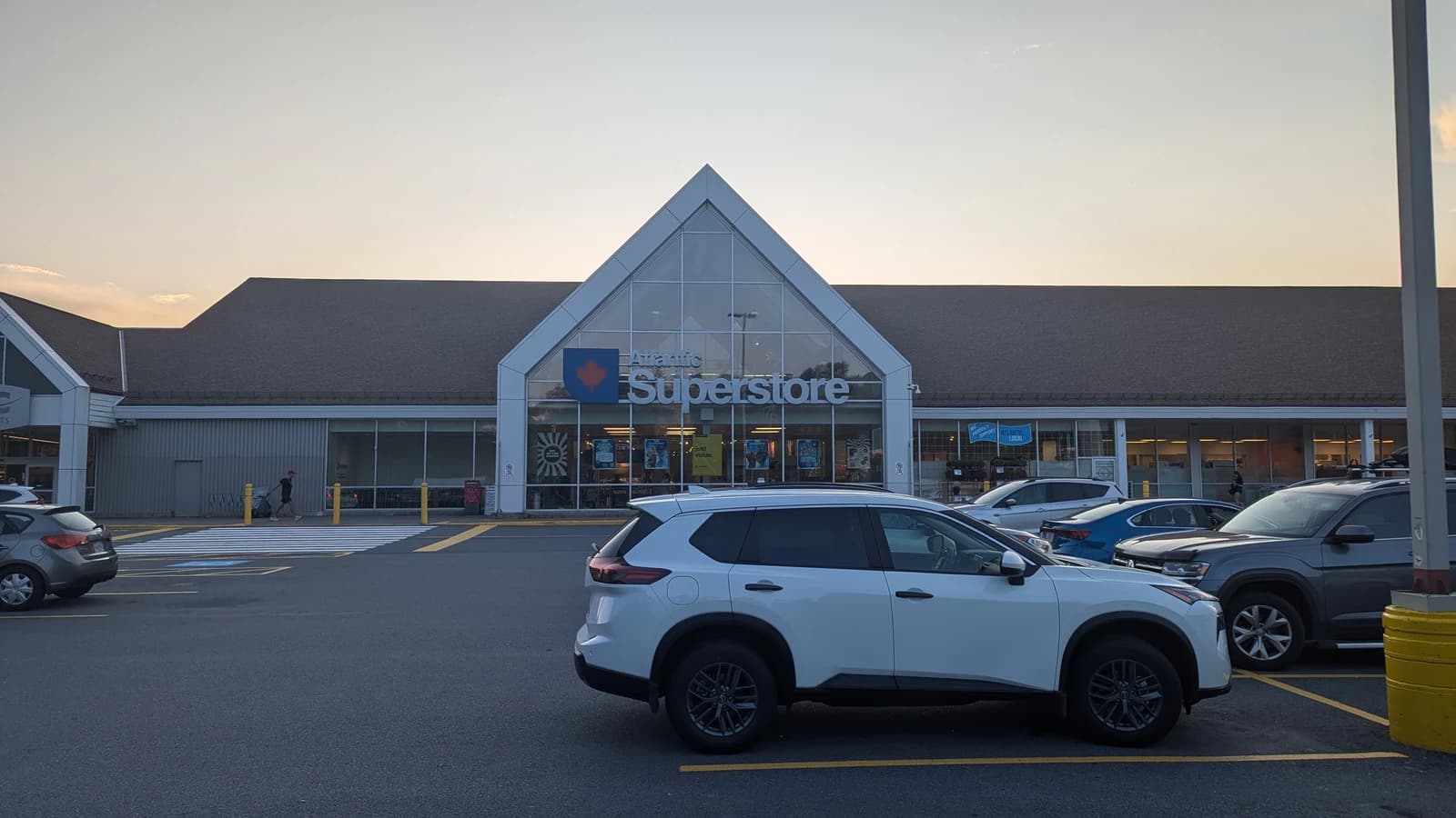 Exterior view of a Real Atlantic Superstore grocery store building at dusk.