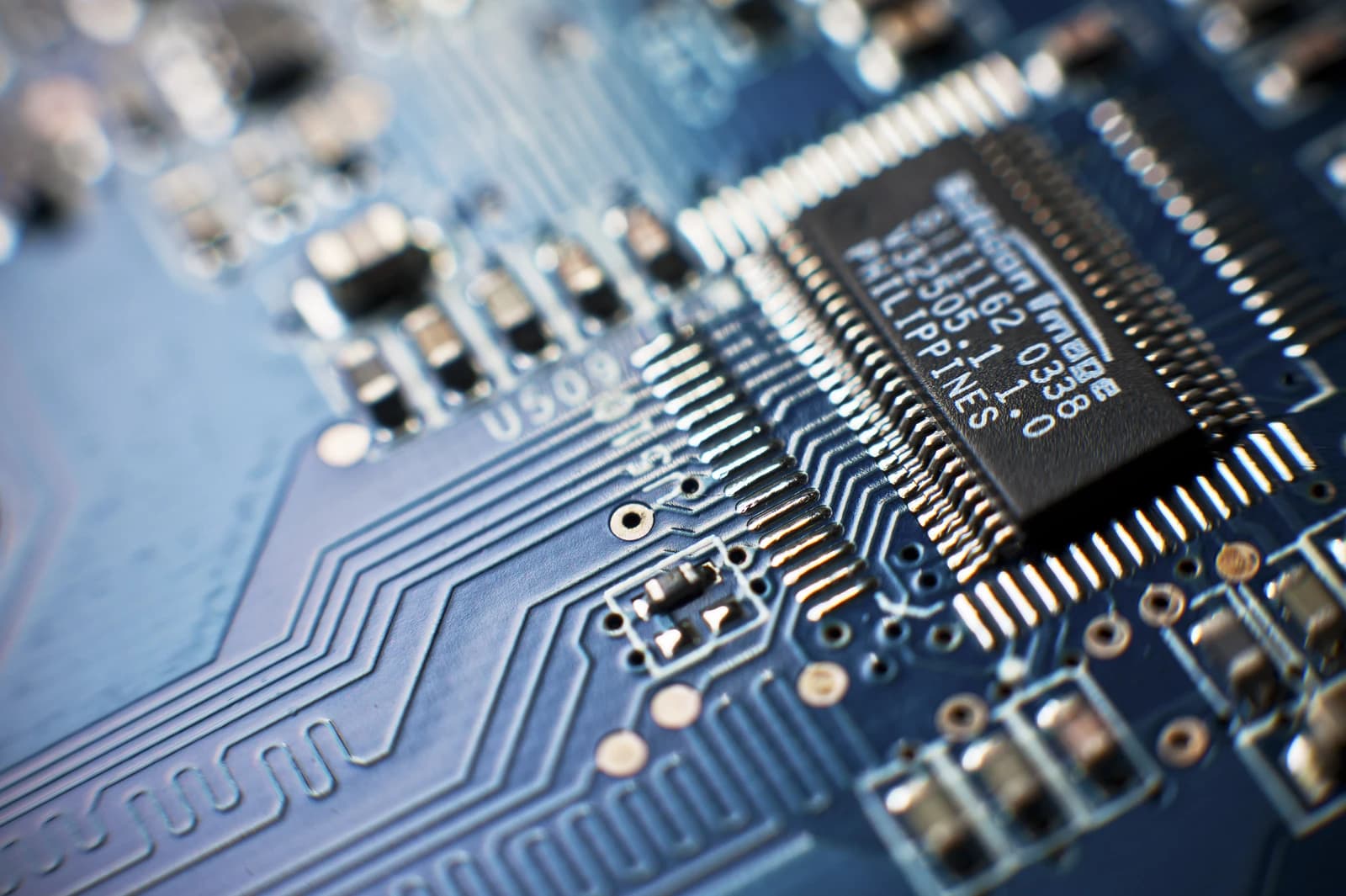 Close-up view of a blue computer circuit board with an integrated circuit.