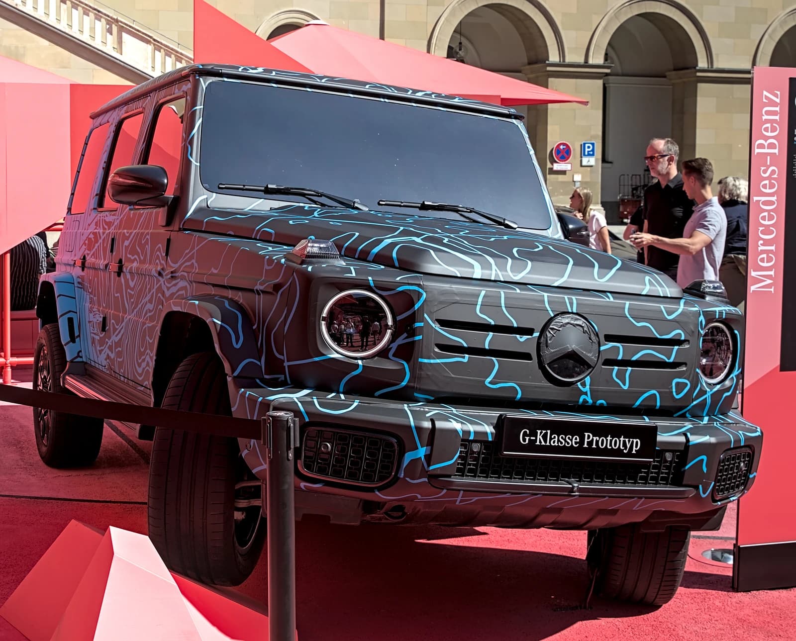 Mercedes-Benz G-Class prototype with camouflage-style livery at an auto show.