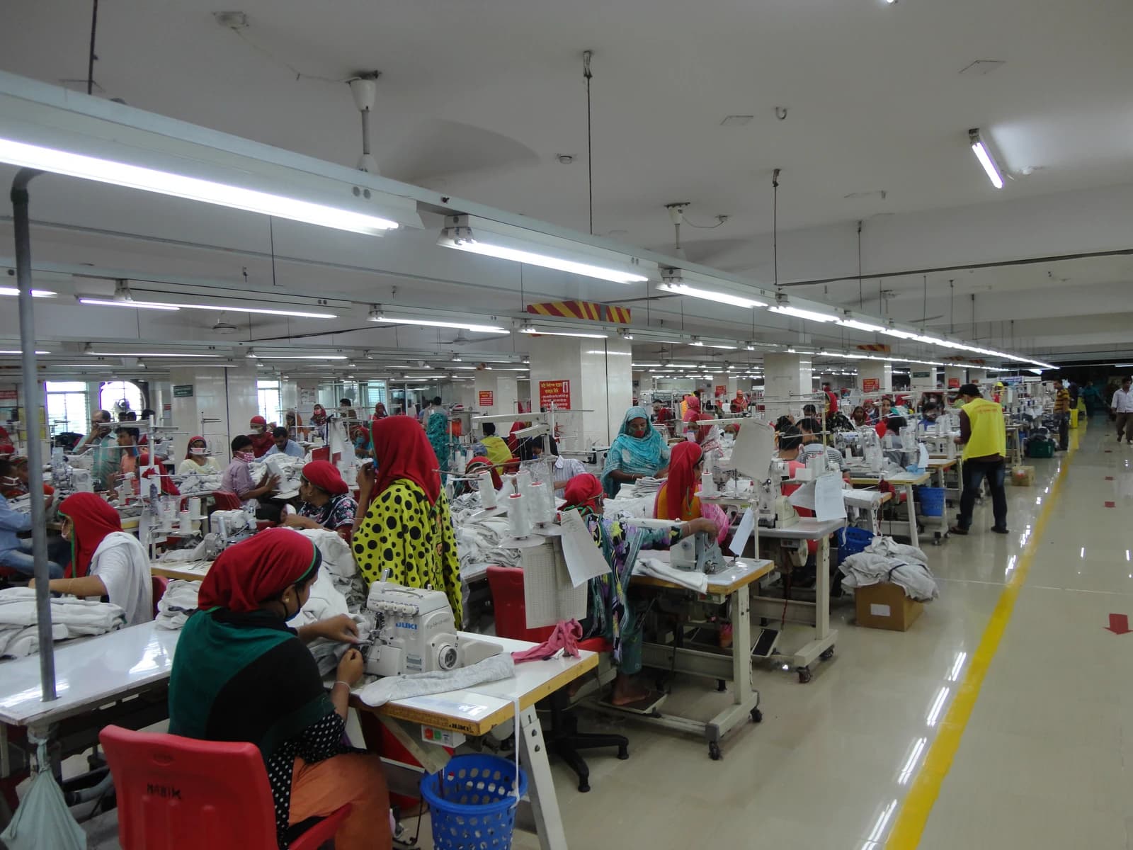 Workers at sewing machines in a large garment factory in Bangladesh.