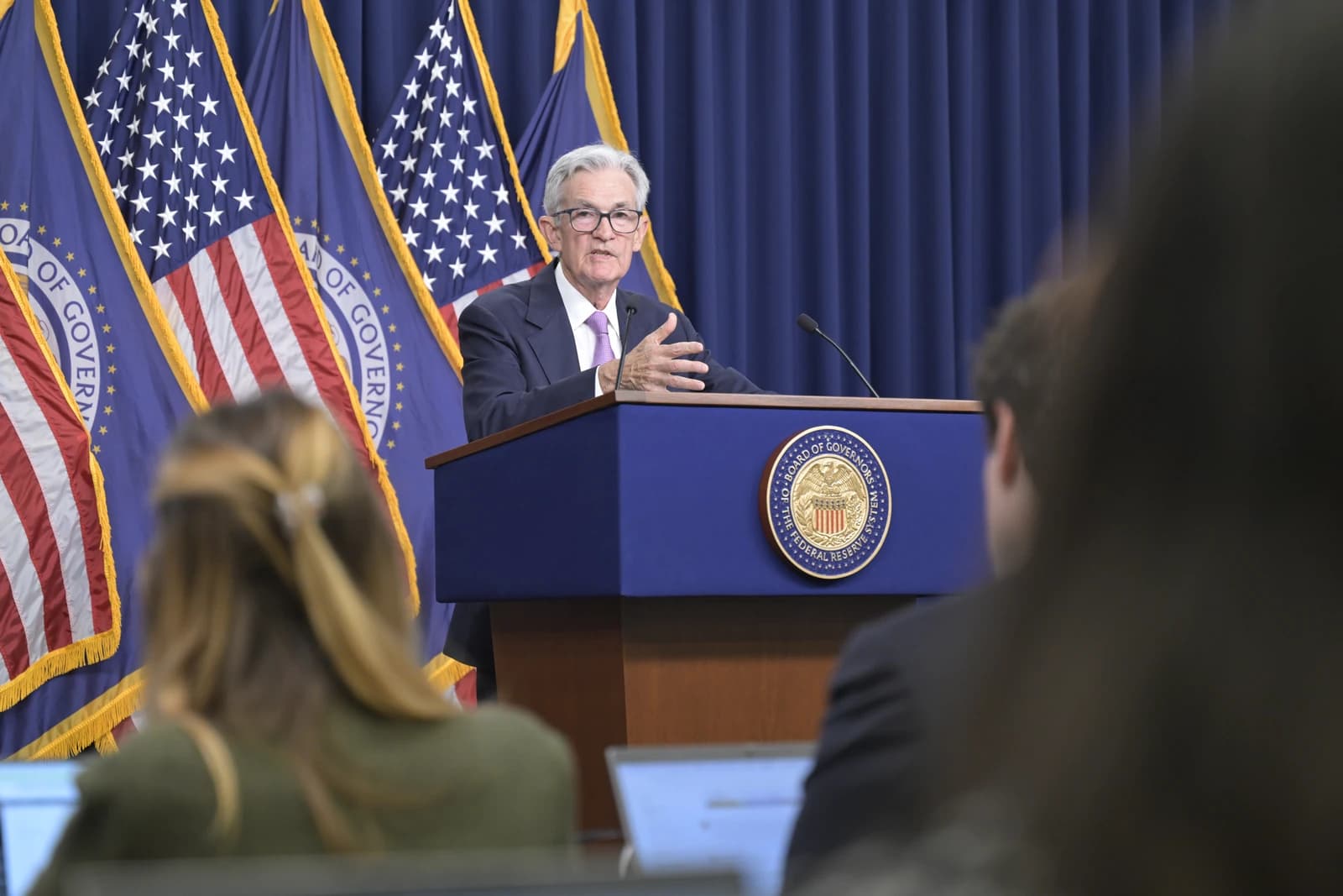 Jerome Powell, Federal Reserve Chairman, speaking at a press conference podium.