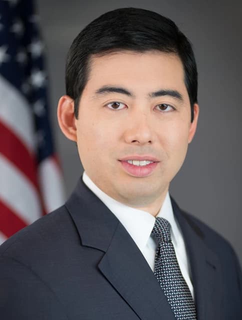 Mark T. Uyeda, SEC Commissioner, poses for an official portrait against a gray background.