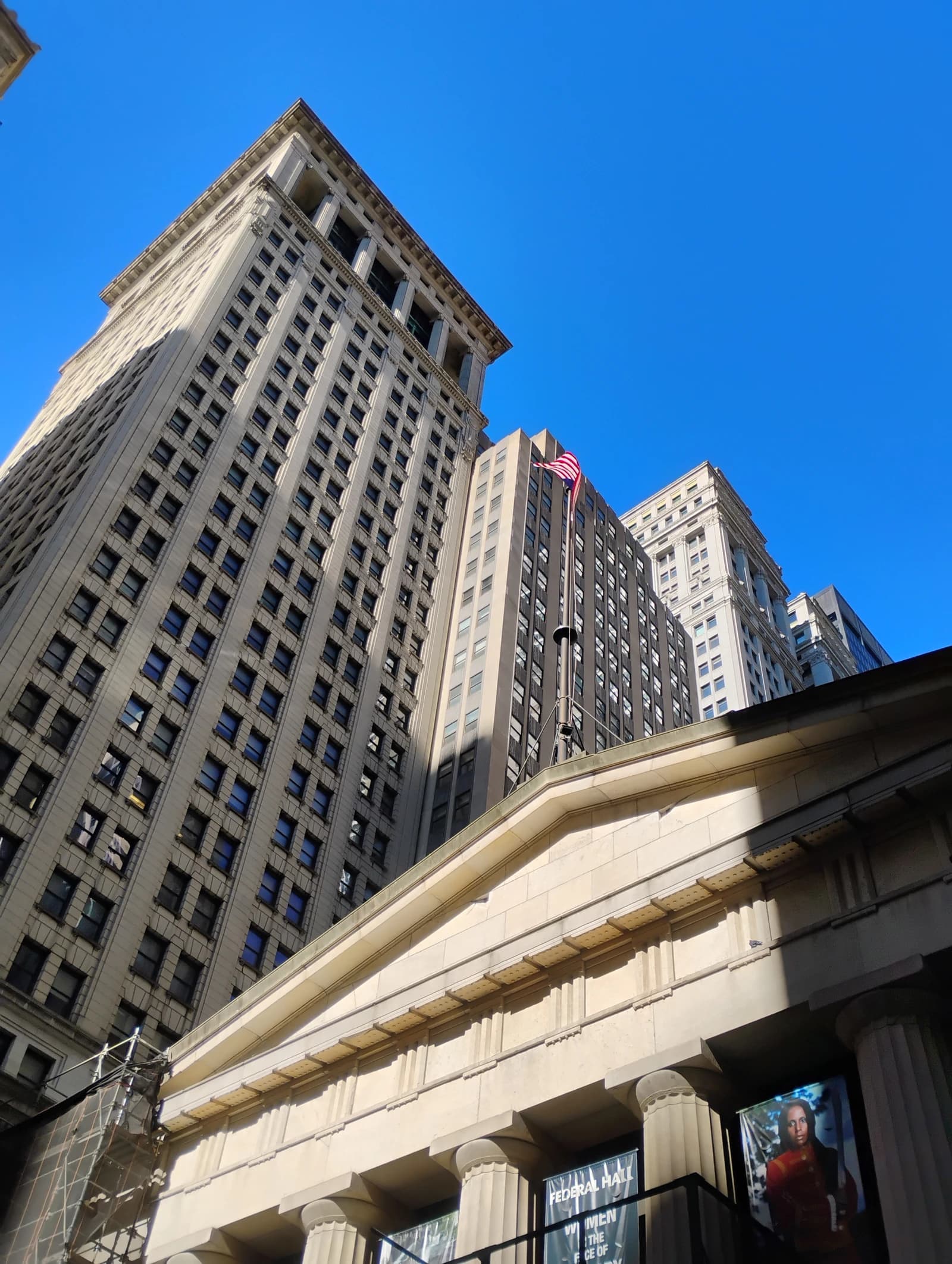 Skyscrapers and building facade with columns and a banner in the Financial District.