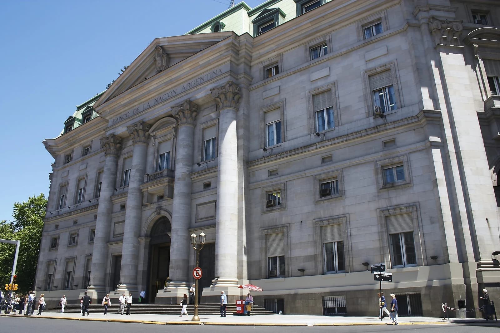 Exterior view of the Banco de la Nación Argentina building with people walking nearby.