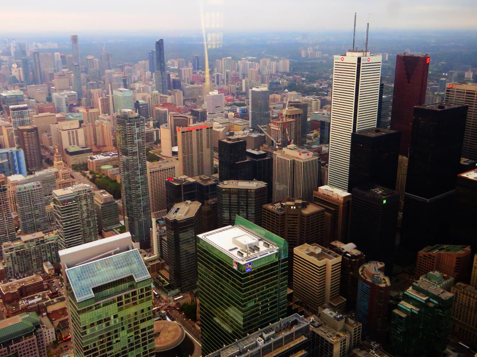 Aerial view of a dense urban financial district skyline with numerous skyscrapers.