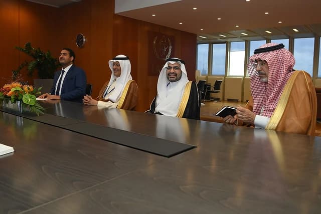 Four men, including Saudi officials, sitting at a conference table during a bilateral meeting.