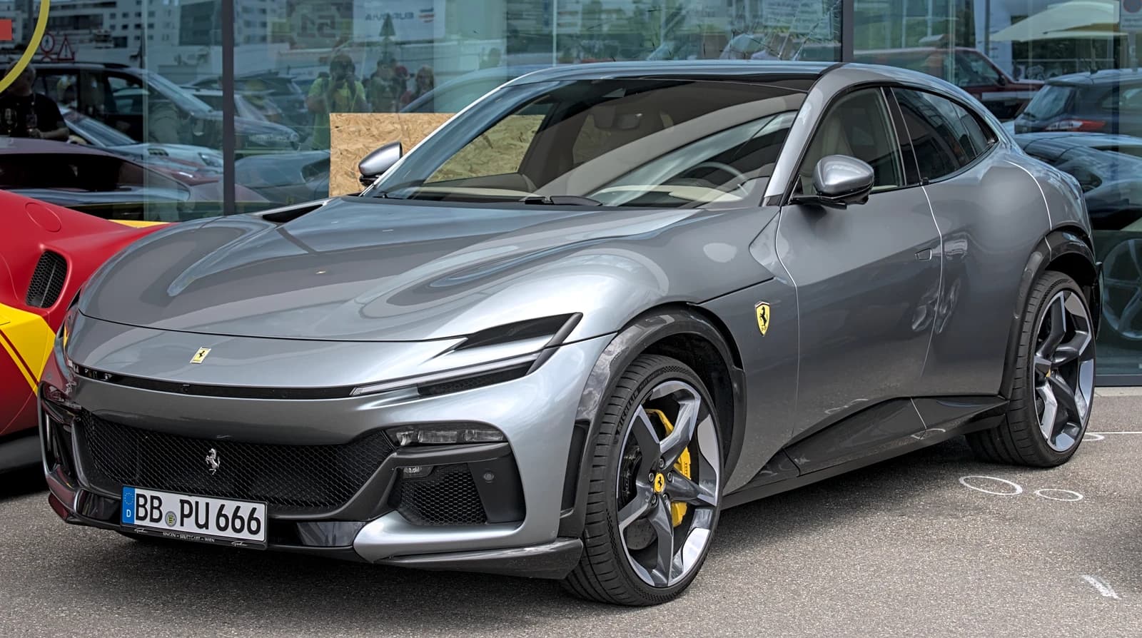 Gray Ferrari Purosangue SUV with yellow brake calipers displayed.