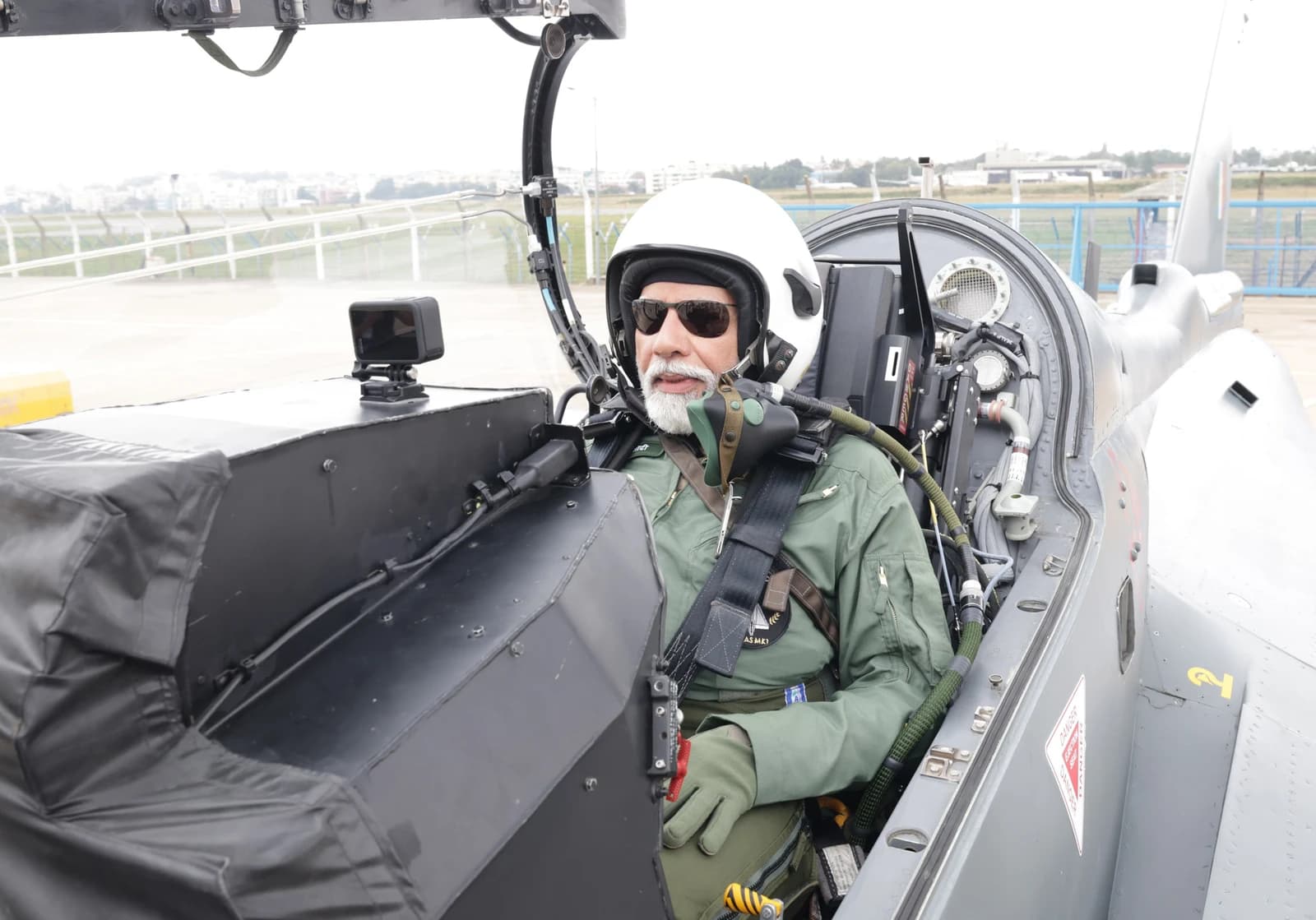 Indian Prime Minister Narendra Modi seated in the cockpit of a fighter jet.