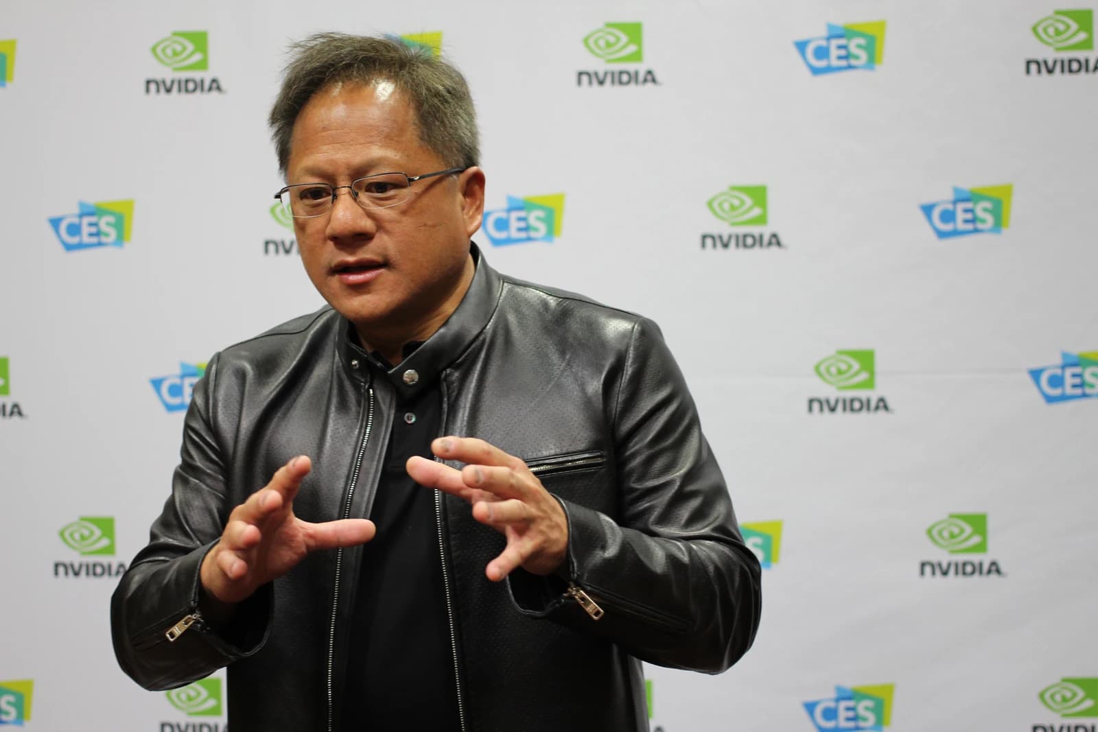 Jensen Huang, CEO of Nvidia, speaking and gesturing with both hands.