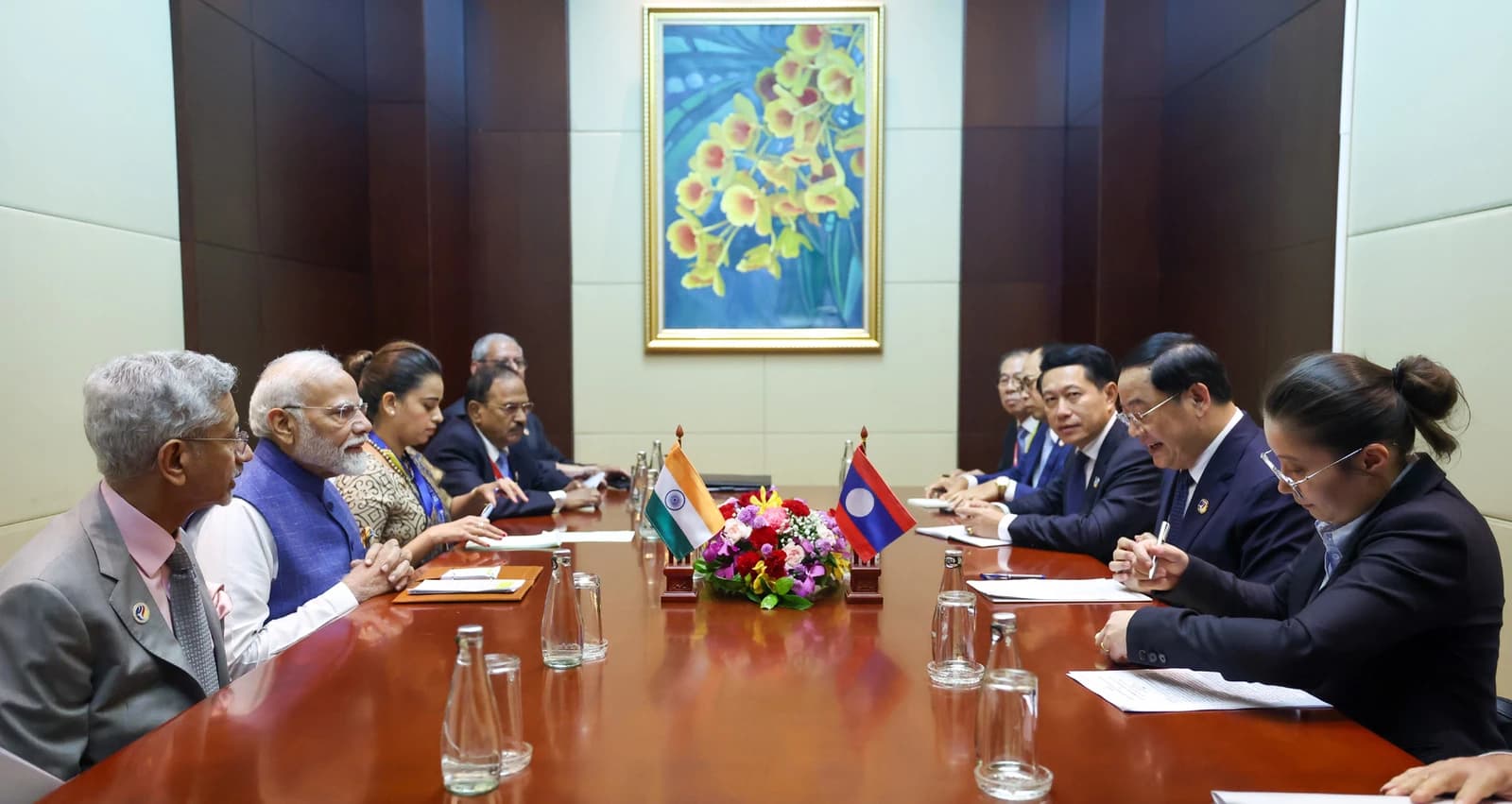 Indian Prime Minister Narendra Modi and Laotian Prime Minister Sonexay Siphandone meeting at a large conference table.