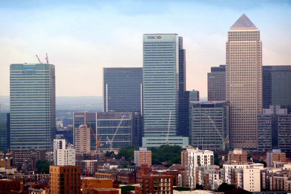 London's financial district skyline with One Canada Square and the HSBC Tower visible.