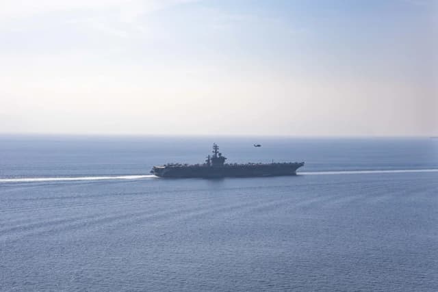 USS Dwight D. Eisenhower aircraft carrier sailing through the Strait of Hormuz.