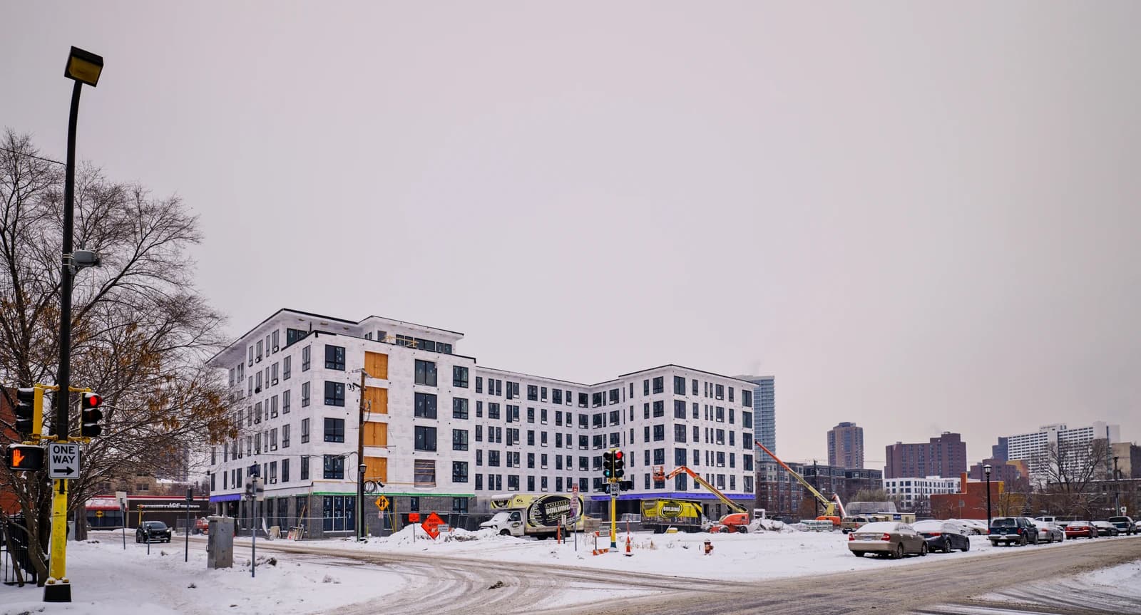 Nicollet and 18th in Minneapolis, mixed-use apartment building under construction in winter.