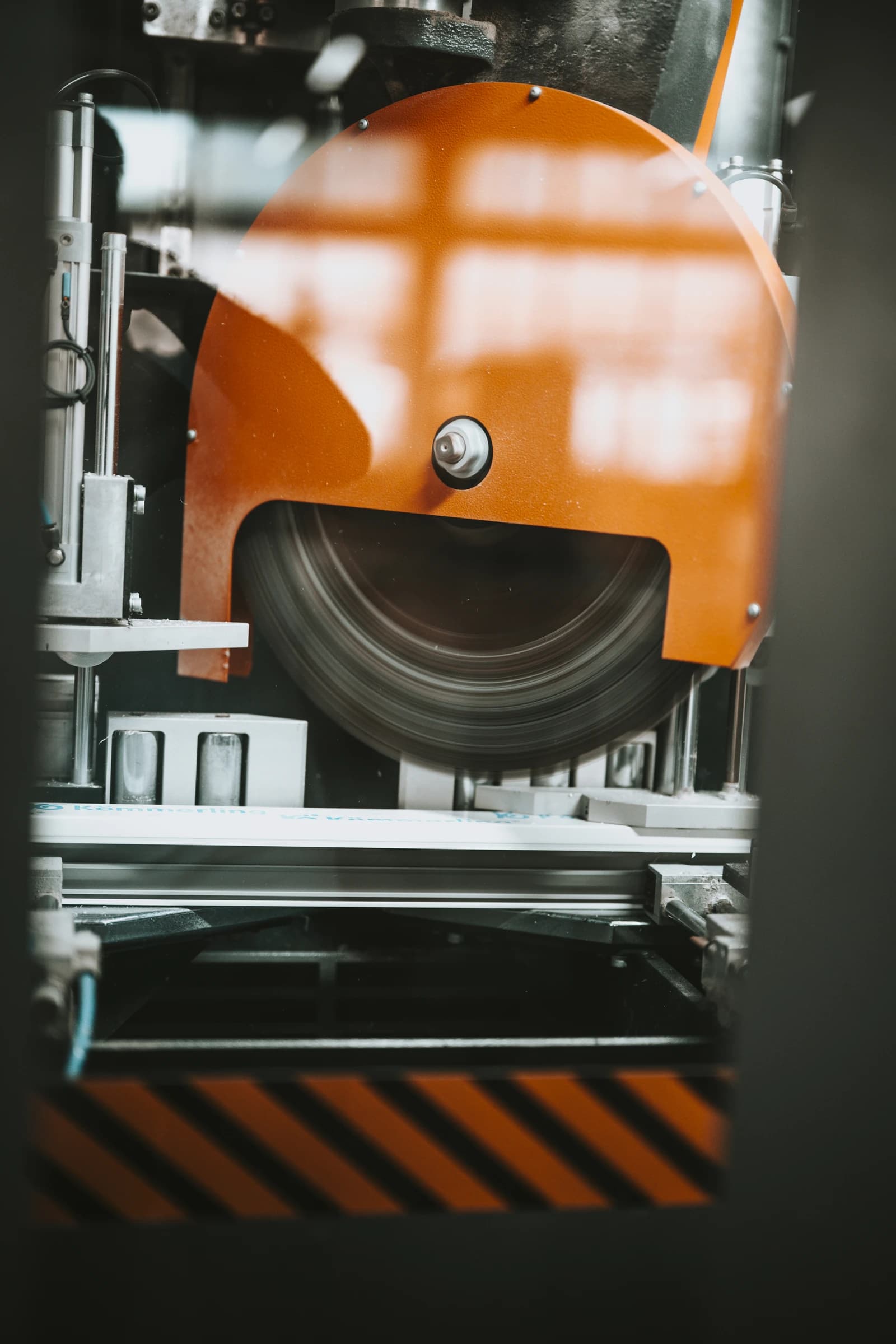 Machine tool actively shaping materials in a busy factory environment.