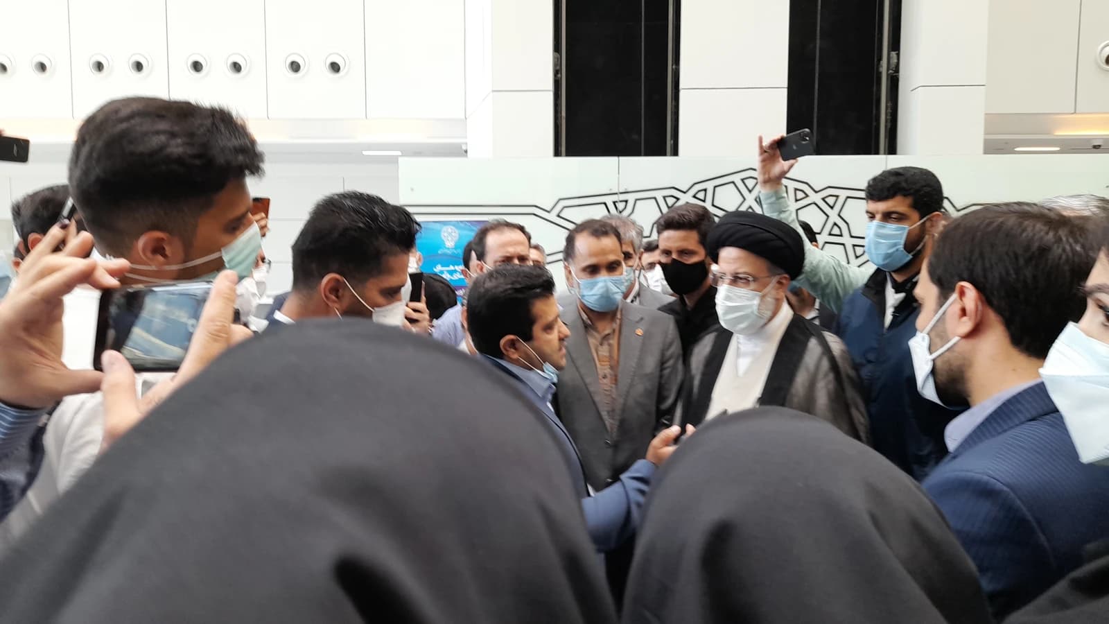 Ebrahim Raisi, then a presidential candidate, interacts with people at the Tehran Stock Exchange.