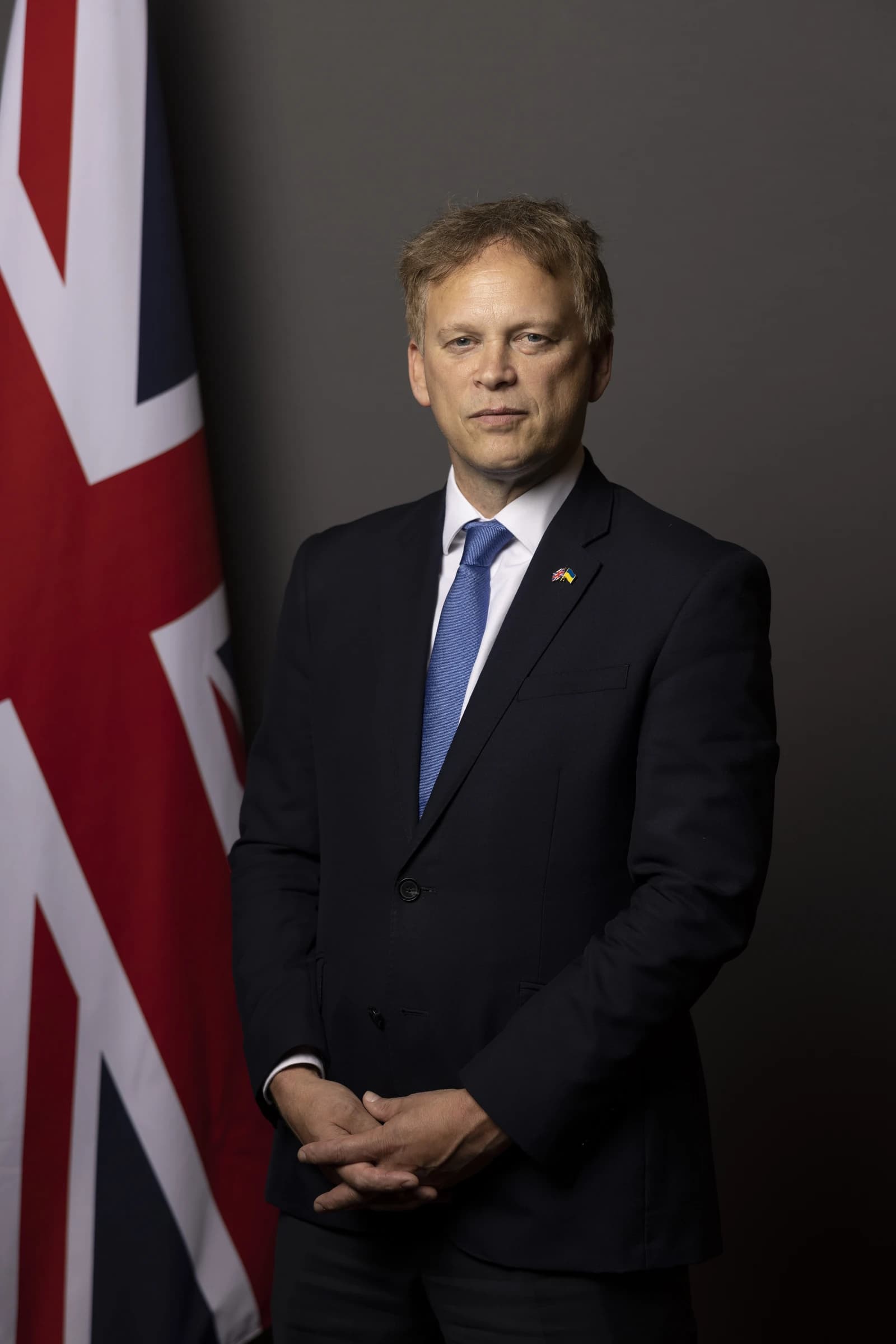 Grant Shapps, British Secretary of State for Defence, stands for an official portrait.