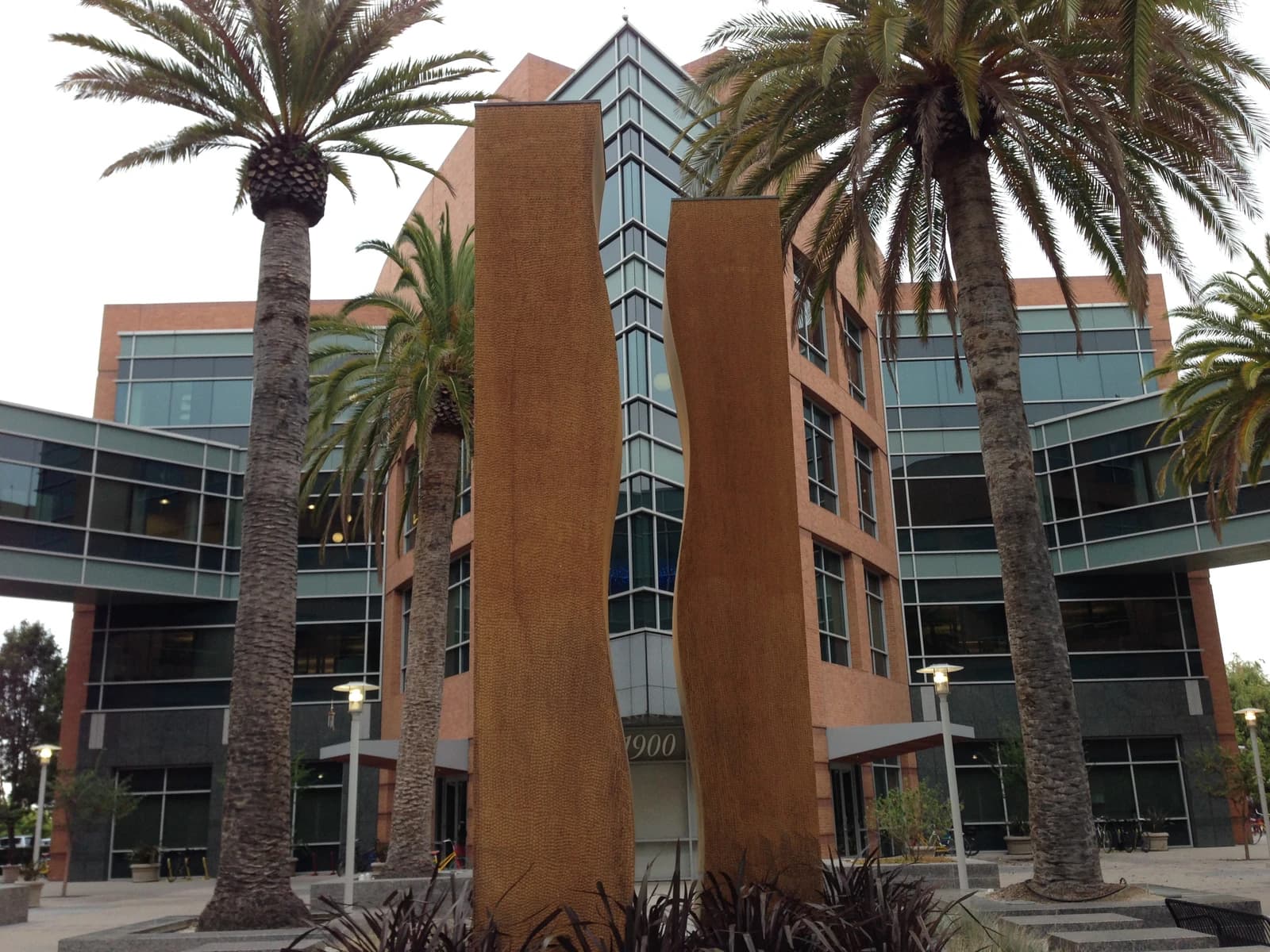 Exterior of Google Building 1900 with palm trees and modern architectural elements.
