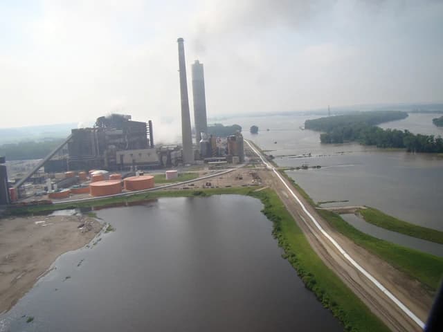 Iatan Power Plant, owned by Evergy, seen from an aerial perspective with surrounding floodwaters.