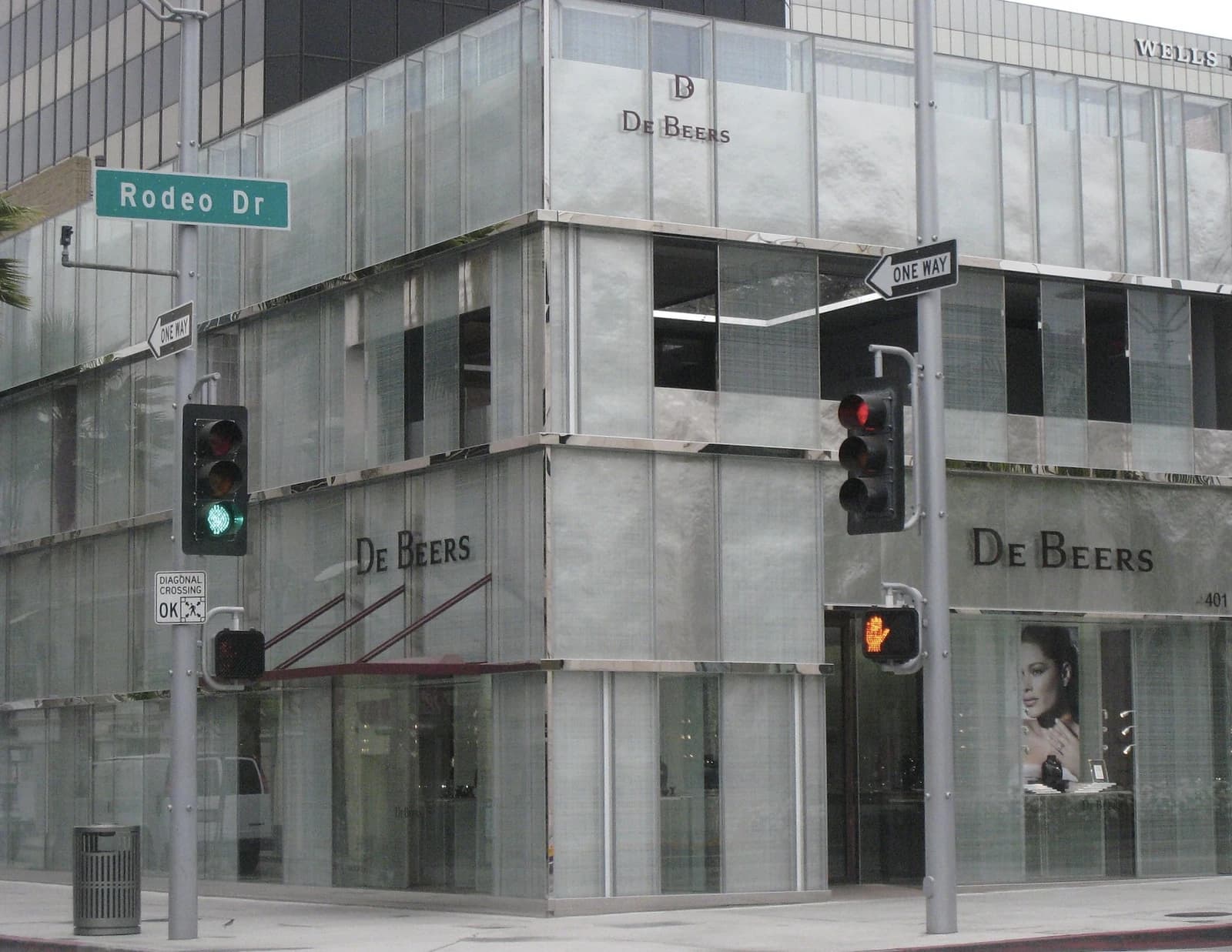 De Beers store exterior with large glass facade and street signs on Rodeo Drive.