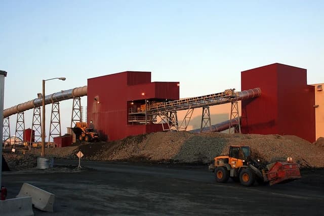 Diamond processing plant building with conveyor belts and mining machinery.