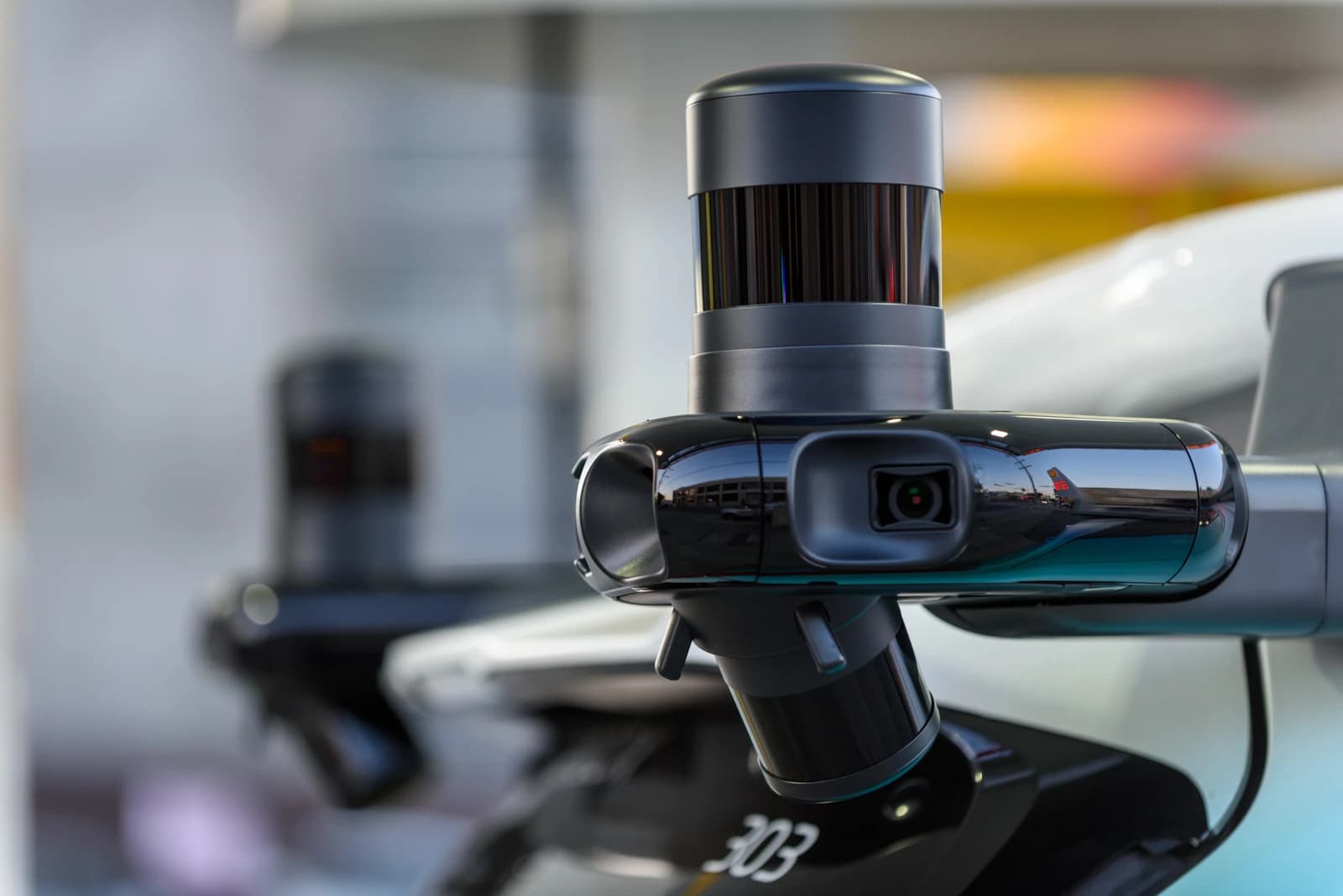 Close-up of an adaptive lidar sensor on a Zoox Toyota Highlander test vehicle.