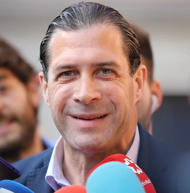 Pedro Fernández Hernández, a Spanish politician, smiling and surrounded by microphones.