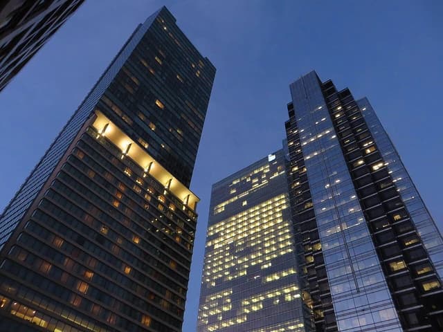 Modern skyscrapers of the Ritz-Carlton Toronto and Simcoe Place against a twilight sky.