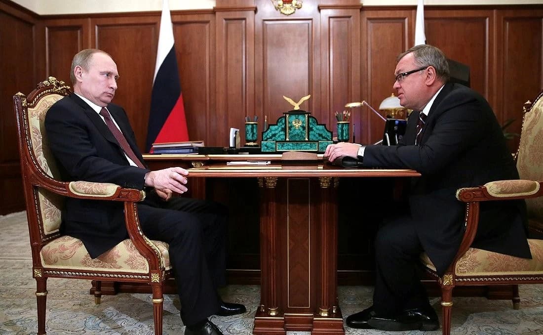 Vladimir Putin, President of Russia, and Andrei Kostin, Chairman and CEO of VTB bank, sitting at a desk.