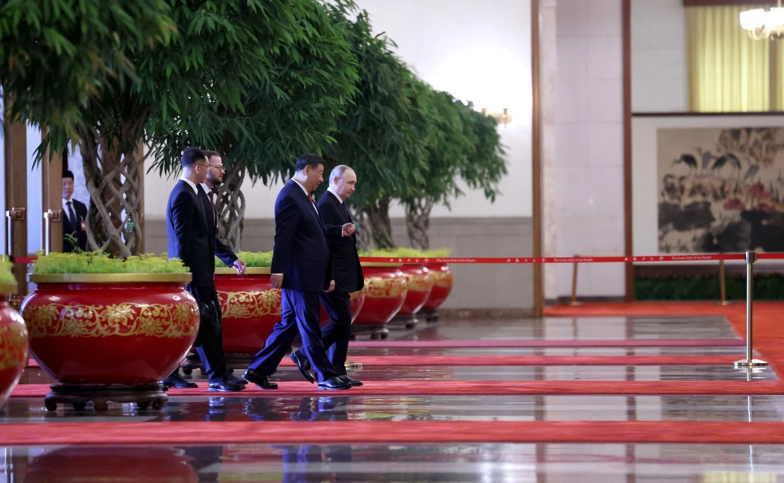 Chinese President Xi Jinping and Russian President Vladimir Putin walking side-by-side indoors.